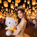 Thai Elegance: Smiling Girl in Yellow Gold Evening Dress with 'Hello Kitty' Among Sky Lanterns